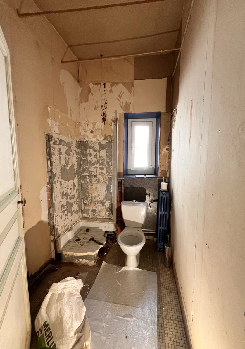 Ancienne salle de douche avant rénovation par Qualidro, plombier chauffagiste à Nantes – installation vétuste, douche et carrelage d’origine.